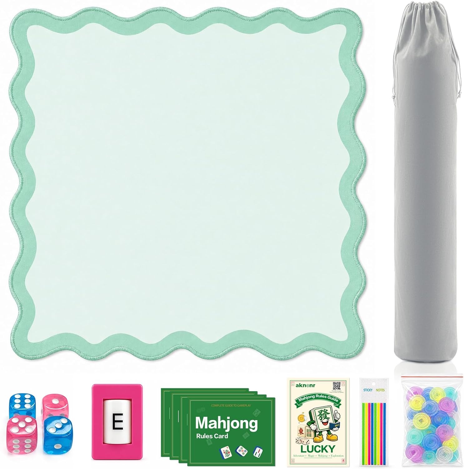 Green scalloped mahjong mat laid flat with a gray drawstring bag, four dice, a wind marker, four rules cards, a rules guide, sticky index tabs and a bag of chips